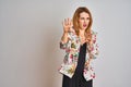 Young caucasian business woman wearing spring floral jacket suit over isolated background afraid and terrified with fear Royalty Free Stock Photo