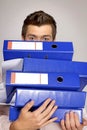Young caucasian businessman holding a stack of binders Royalty Free Stock Photo