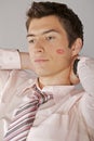 Young caucasian businessman with lipstick kiss mark on his cheek