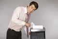 Young caucasian businessman shredding documents