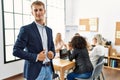 Young caucasian businessman smiling happy standing at the office during business meeting Royalty Free Stock Photo