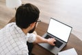 Young caucasian businessman use laptop computer with white blank screen Royalty Free Stock Photo