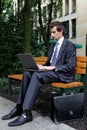 young caucasian businessman using his laptop in park Royalty Free Stock Photo