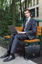 young caucasian businessman using his laptop in park Royalty Free Stock Photo