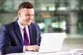 Young Caucasian businessman using laptop computer at work Royalty Free Stock Photo