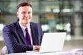 Young Caucasian businessman using laptop computer at work Royalty Free Stock Photo