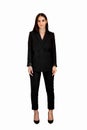 A young Caucasian businesswoman girl in a black Trouser suit stands tall on a white isolated background