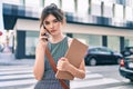 Young caucasian businesswoman with serious expression talking on the smartphone at the city Royalty Free Stock Photo