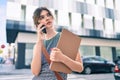 Young caucasian businesswoman with serious expression talking on the smartphone at the city Royalty Free Stock Photo