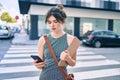 Young caucasian businesswoman with serious expression using smartphone at the city Royalty Free Stock Photo