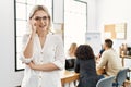 Young caucasian businesswoman smiling happy standing with arms crossed gesture at the office during business meeting Royalty Free Stock Photo