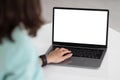 Young caucasian businesswoman in suit at table typing on laptop with blank screen in office interior, cropped Royalty Free Stock Photo