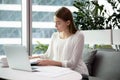 Young Caucasian businesswoman work on laptop in office Royalty Free Stock Photo