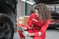 Young Caucasian car mechanic with a checklist, Technician checking modern car at garage, Car repair and maintenance concepts Royalty Free Stock Photo