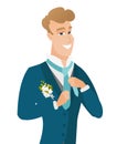 Young caucasian cheerful groom adjusting tie.