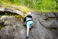 Young caucasian child boy climbing rocks in forest Royalty Free Stock Photo