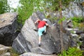 Young caucasian child boy climbing rocks in forest Royalty Free Stock Photo