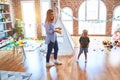 Young caucasian child playing at playschool with teacher