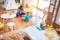 Young caucasian child playing at playschool with teacher