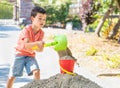 Young Caucasian Chinese Boy Playing with Shovel and Bucket