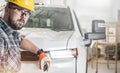 Young Caucasian Construction Contractor Wearing Eyes Protection Glasses and a Hard Hat