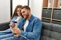 Young caucasian couple buying using smartphone and credit card at home Royalty Free Stock Photo