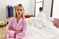 Young caucasian couple in conflict sitting on the bed at home Royalty Free Stock Photo
