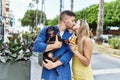 Young caucasian couple eating ice cream and kissing standing with dog at the city Royalty Free Stock Photo