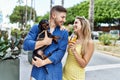 Young caucasian couple eating ice cream smiling happy with dog at the city Royalty Free Stock Photo