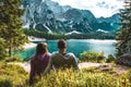 Young caucasian couple enjoying the peaceful view of Baires Lake in the Dolomite mountains, Italy Royalty Free Stock Photo