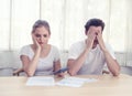 Young caucasian couple hand holding credit card and debt bill on table in home,men and women have overdue financial foreclosure Royalty Free Stock Photo