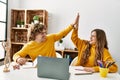 Young caucasian couple high five raised up hands having online art class at home