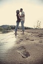 Cute couple on beach with footprints in sand Royalty Free Stock Photo