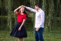 Young caucasian couple in love dancing in the park Royalty Free Stock Photo