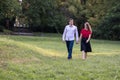 Young couple in love walking in the park, holding hands Royalty Free Stock Photo