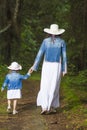 Young caucasian Couple of Mother and Daughter Taking a Stroll in Green Summer Forest. Royalty Free Stock Photo