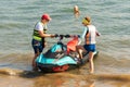 Young Caucasian couple mounting jet ski watercraft on summer sunny day