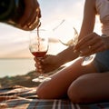 Young caucasian couple pouring red wine into glasses Royalty Free Stock Photo