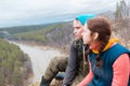 Young caucasian couple sitting the hillside to the river Royalty Free Stock Photo