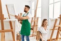 Young caucasian couple smiling happy drawing at art studio Royalty Free Stock Photo