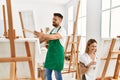 Young caucasian couple smiling happy drawing at art studio Royalty Free Stock Photo