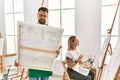 Young caucasian couple smiling happy drawing at art studio Royalty Free Stock Photo