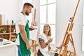 Young caucasian couple smiling happy drawing at art studio Royalty Free Stock Photo