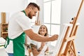 Young caucasian couple smiling happy drawing at art studio Royalty Free Stock Photo