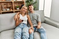 Young caucasian couple smiling happy toasting with red wine at home Royalty Free Stock Photo