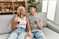 Young caucasian couple smiling happy toasting with red wine at home Royalty Free Stock Photo