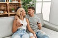 Young caucasian couple smiling happy toasting with red wine at home Royalty Free Stock Photo