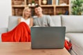 Young caucasian couple smiling happy watching movie eating popcorn at home Royalty Free Stock Photo