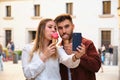 Young Caucasian couple taking a selfie while eating an ice cream. Royalty Free Stock Photo