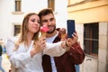 Young Caucasian couple taking a selfie while eating an ice cream. Royalty Free Stock Photo